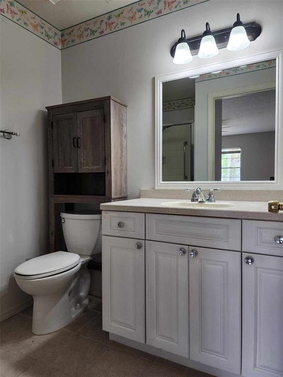 1102 Halton Court, Unit 1102 Sun City Center, FL 33573 - Photo 16 of 58 a bathroom with a toilet sink and mirror