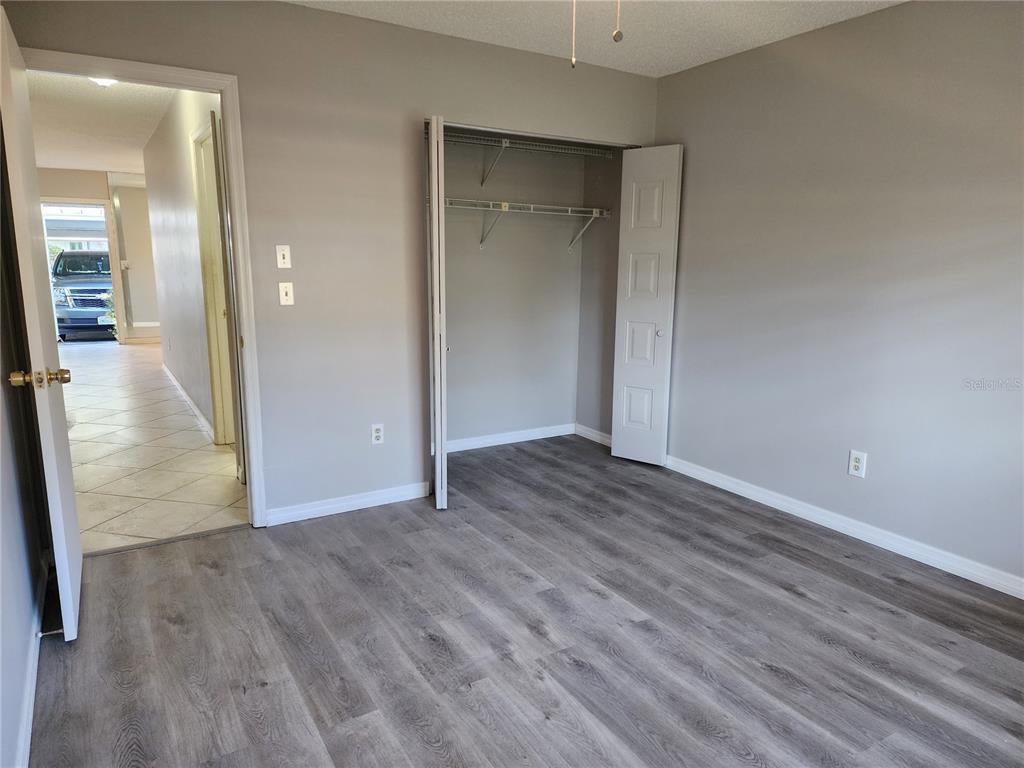 1102 Halton Court, Unit 1102 Sun City Center, FL 33573 - Photo 18 of 58 a view of a hallway with wooden floor
