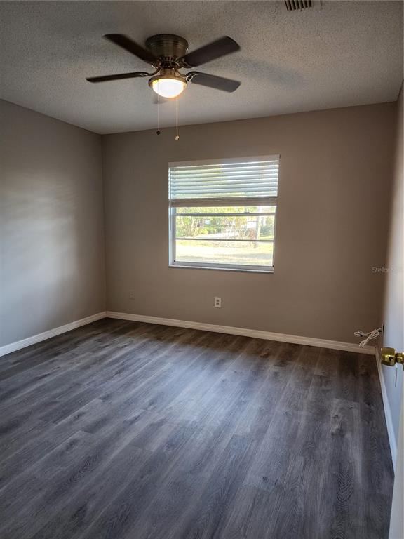 1102 Halton Court, Unit 1102 Sun City Center, FL 33573 - Photo 19 of 58 an empty room with wooden floor and windows