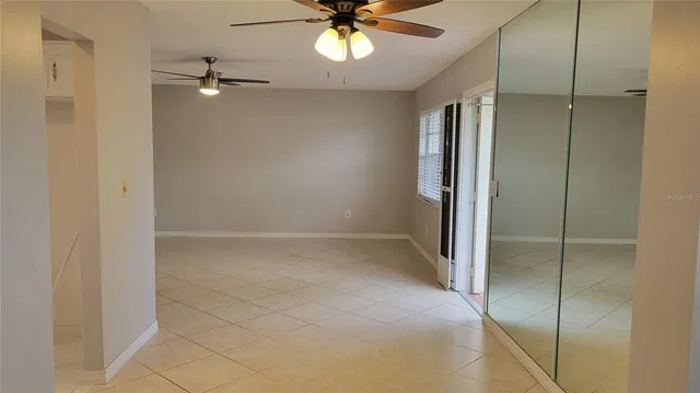 a view of a hallway with wooden floor and a chandelier
