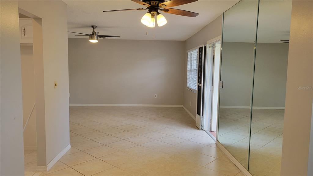 1102 Halton Court, Unit 1102 Sun City Center, FL 33573 - Photo 26 of 58 a view of an empty room with a ceiling fan