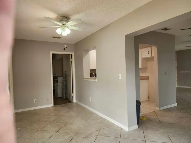 a view of a storage & utility room with a fridge
