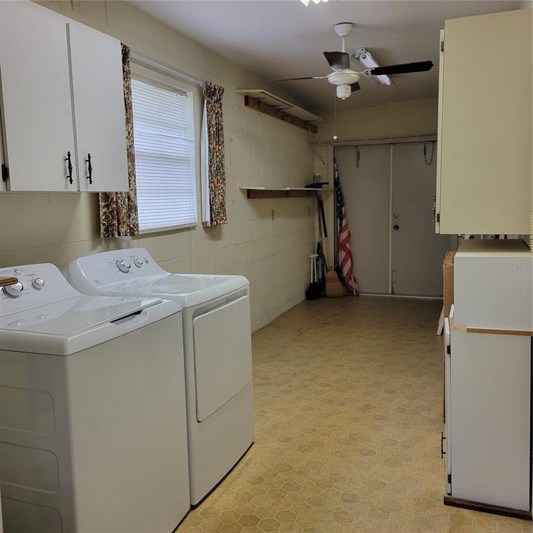 1102 Halton Court, Unit 1102 Sun City Center, FL 33573 - Photo 32 of 58 a utility room with cabinets washer and dryer