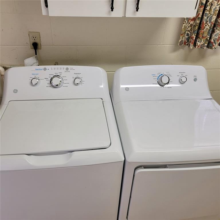 1102 Halton Court, Unit 1102 Sun City Center, FL 33573 - Photo 34 of 58 a utility room with dryer and washer