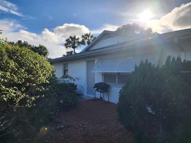 a living room with furniture and kitchen