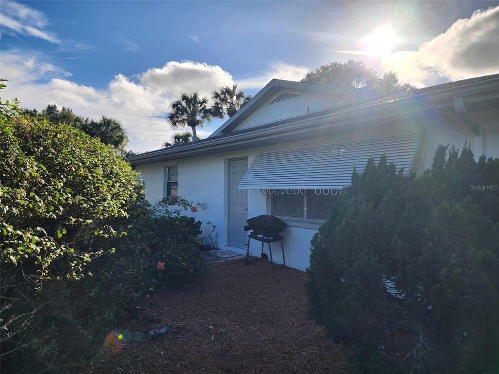 1102 Halton Court, Unit 1102 Sun City Center, FL 33573 - Photo 45 of 58 a view of a chair and table in the patio next to a yard