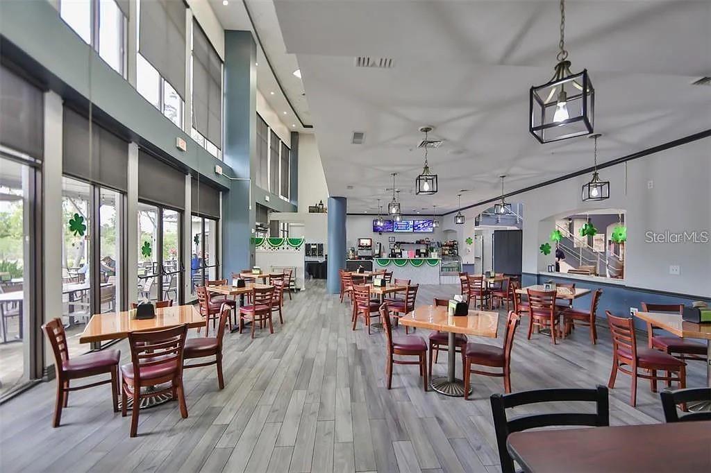 1102 Halton Court, Unit 1102 Sun City Center, FL 33573 - Photo 53 of 58 a view of a dining room with furniture window and wooden floor