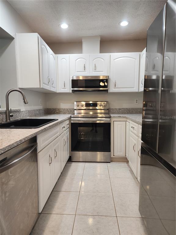 1102 Halton Court, Unit 1102 Sun City Center, FL 33573 - Photo 7 of 58 a large kitchen with stainless steel appliances granite countertop a stove sink and cabinets