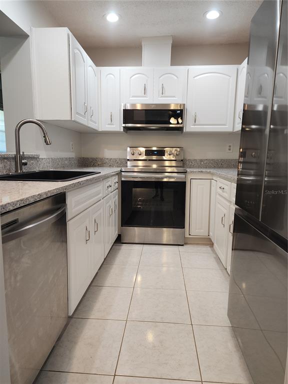 1102 Halton Court, Unit 1102 Sun City Center, FL 33573 - Photo 9 of 58 a kitchen with stainless steel appliances granite countertop a stove a sink and a microwave