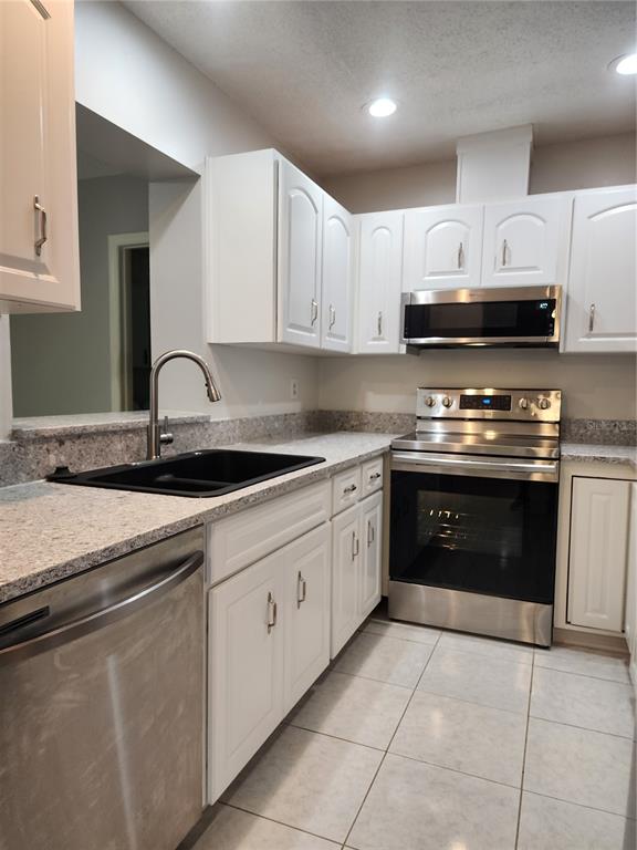 1102 Halton Court, Unit 1102 Sun City Center, FL 33573 - Photo 10 of 58 a kitchen with stainless steel appliances granite countertop a sink and a stove
