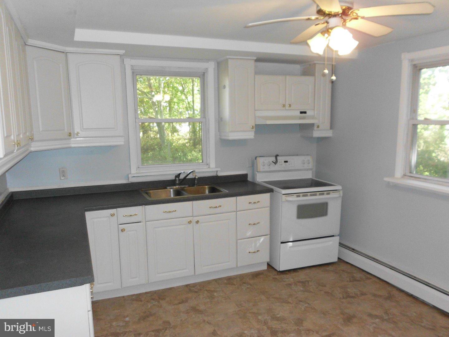 172 Arneys Mt Road Pemberton, NJ 08068 - Photo 13 of 24 a kitchen with granite countertop white cabinets and window