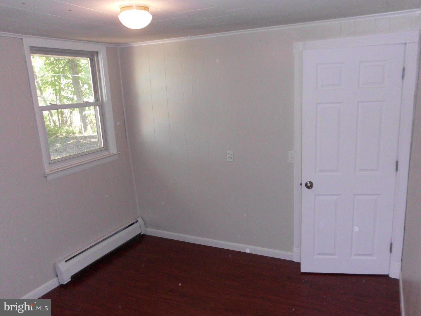 172 Arneys Mt Road Pemberton, NJ 08068 - Photo 23 of 24 an empty room with wooden floor and windows