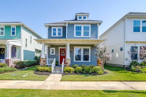 a front view of a house with garden and porch