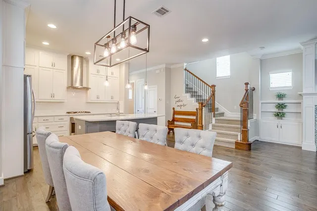 a large kitchen with a table and chairs
