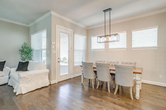 a view of a dining room with furniture window and wooden floor