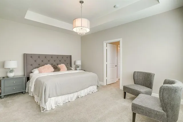 a spacious bedroom with a bed and a couch