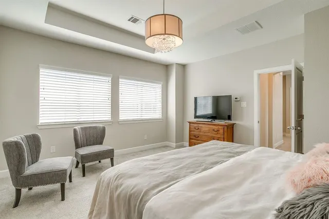 a bedroom with a bed and a television