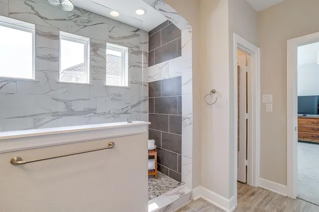 a bathroom with a shower and a sink
