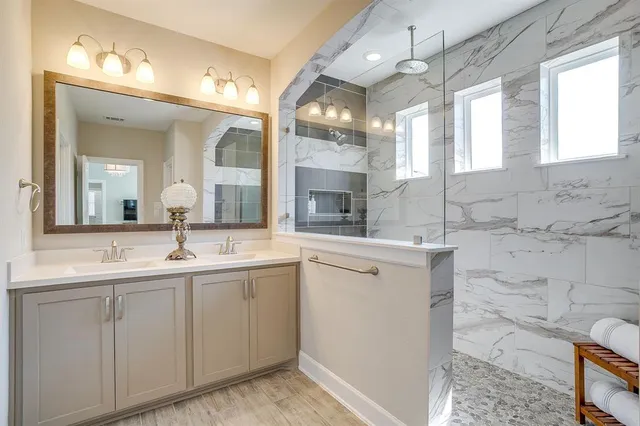 a spacious bathroom with a double vanity sink and a mirror
