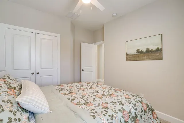 a bedroom with a bed and a painting on the wall