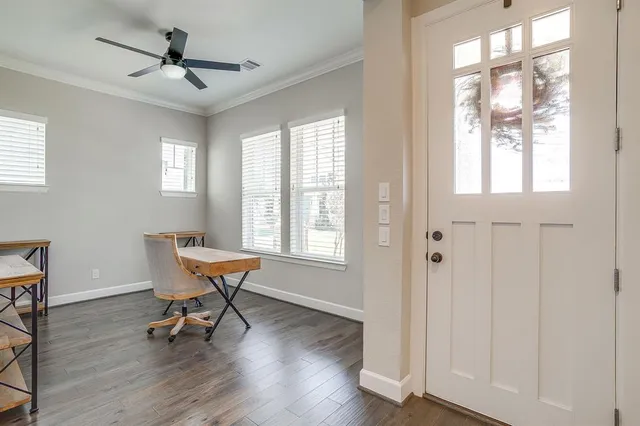 a work room with wooden floor and a window
