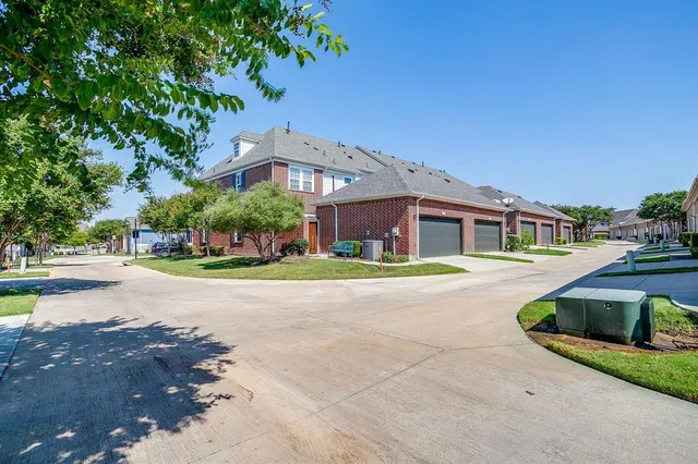 a front view of a house with yard and green space