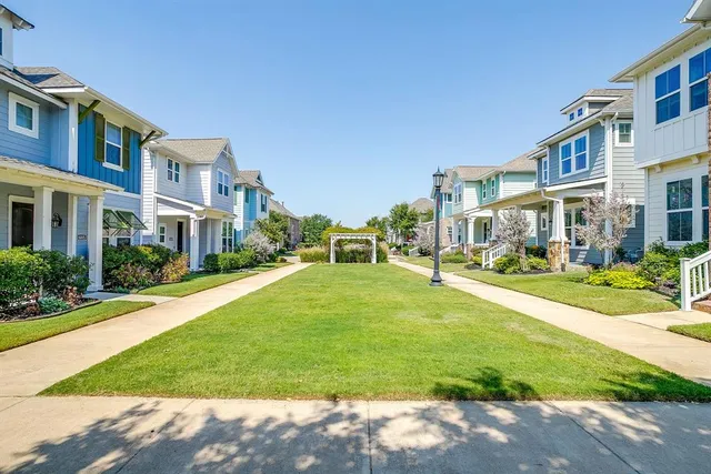 a front view of a residential apartment building with a yard