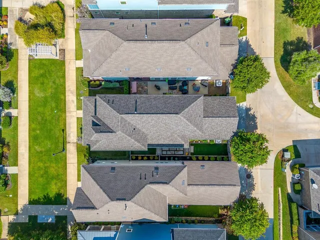 an aerial view of a house with a yard