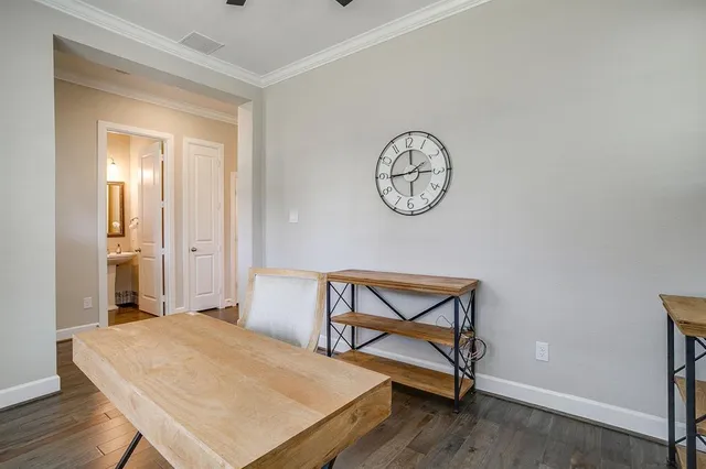 a view of a room that has a table and a chair in it