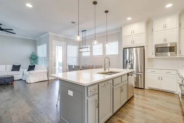 a kitchen with white cabinets and stainless steel appliances