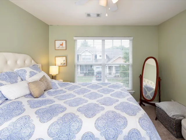 a bedroom with a bed and a chandelier