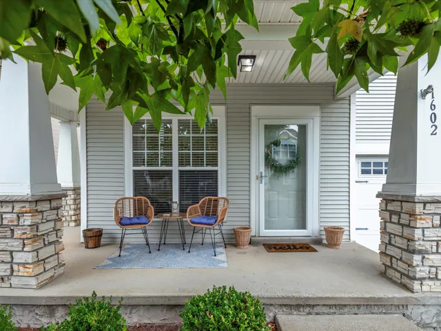 a backyard of a house with outdoor seating