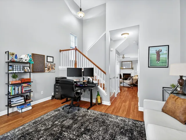 a living room with furniture and a book shelf