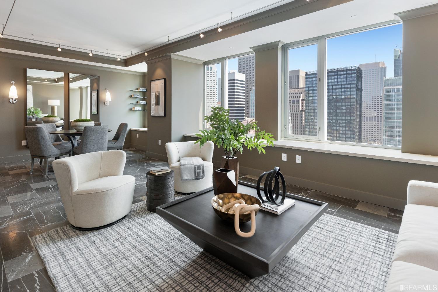 a living room with furniture and floor to ceiling windows