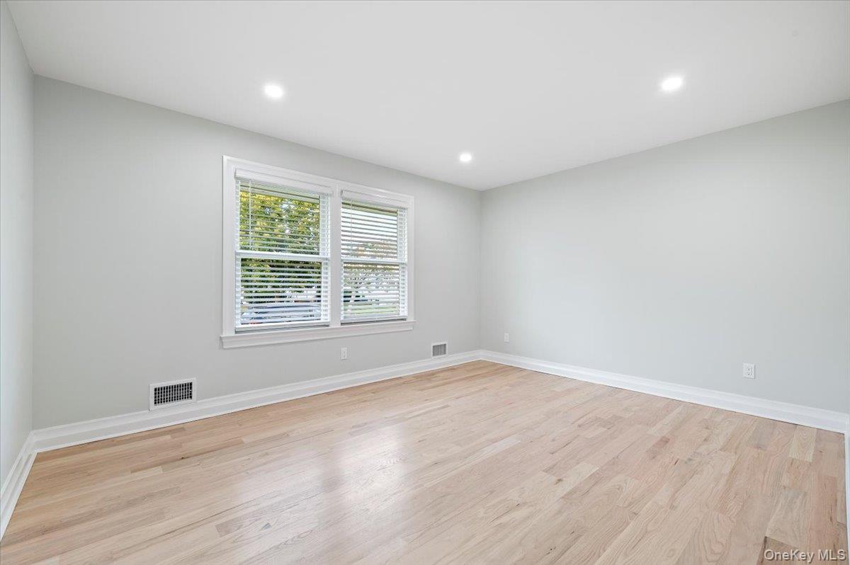 168 Martens Avenue Valley Stream, NY 11580 - Photo 11 of 26 Unfurnished room with light wood-style floors and recessed lighting
