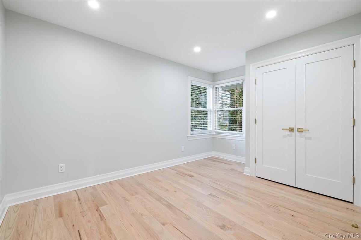 168 Martens Avenue Valley Stream, NY 11580 - Photo 12 of 26 Unfurnished bedroom featuring recessed lighting, light wood-type flooring, and a closet