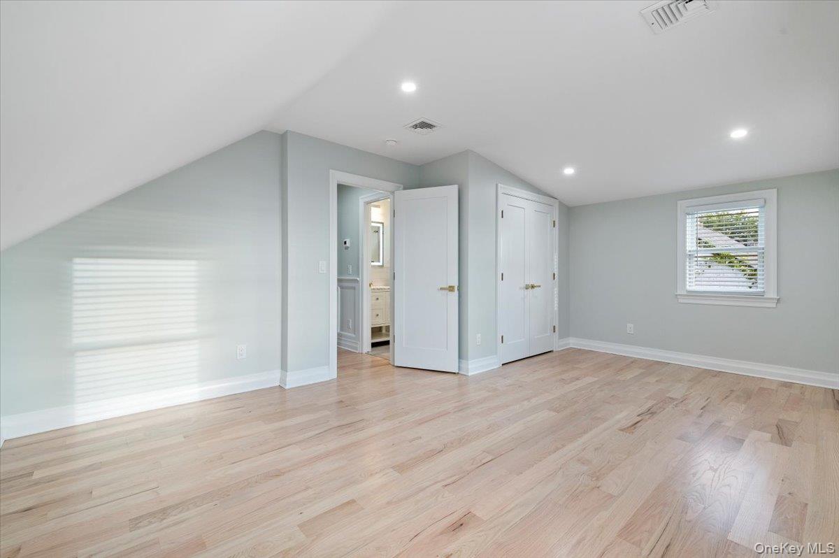 168 Martens Avenue Valley Stream, NY 11580 - Photo 13 of 26 Additional living space with light wood finished floors, vaulted ceiling, and recessed lighting