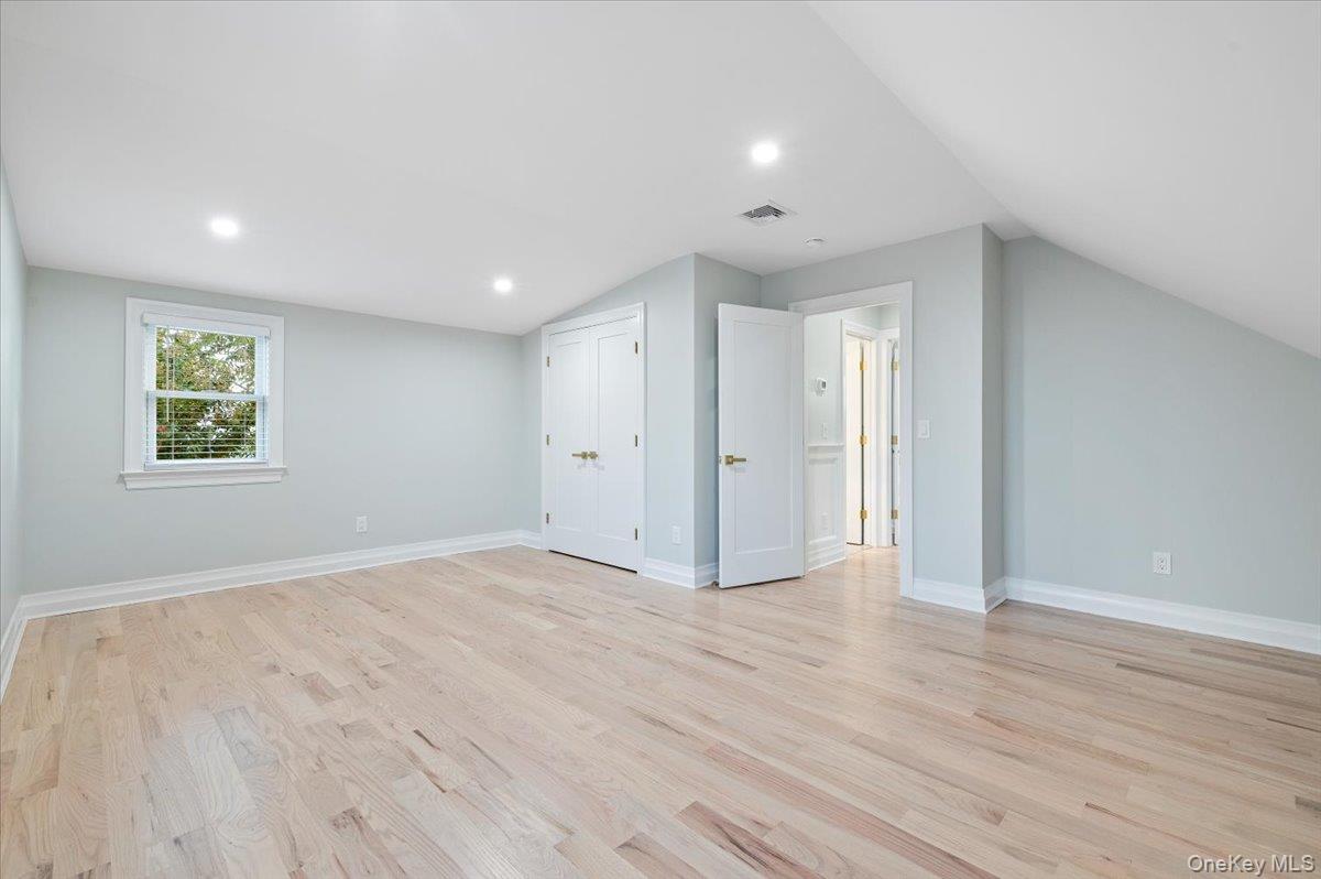 168 Martens Avenue Valley Stream, NY 11580 - Photo 16 of 26 Bonus room featuring light wood finished floors, recessed lighting, and lofted ceiling