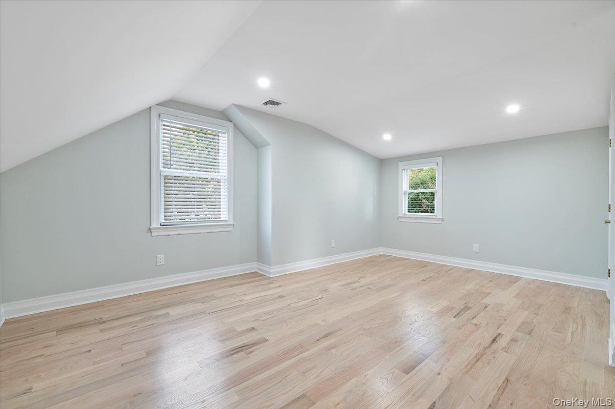 168 Martens Avenue Valley Stream, NY 11580 - Photo 17 of 26 Additional living space featuring light wood finished floors, recessed lighting, and vaulted ceiling
