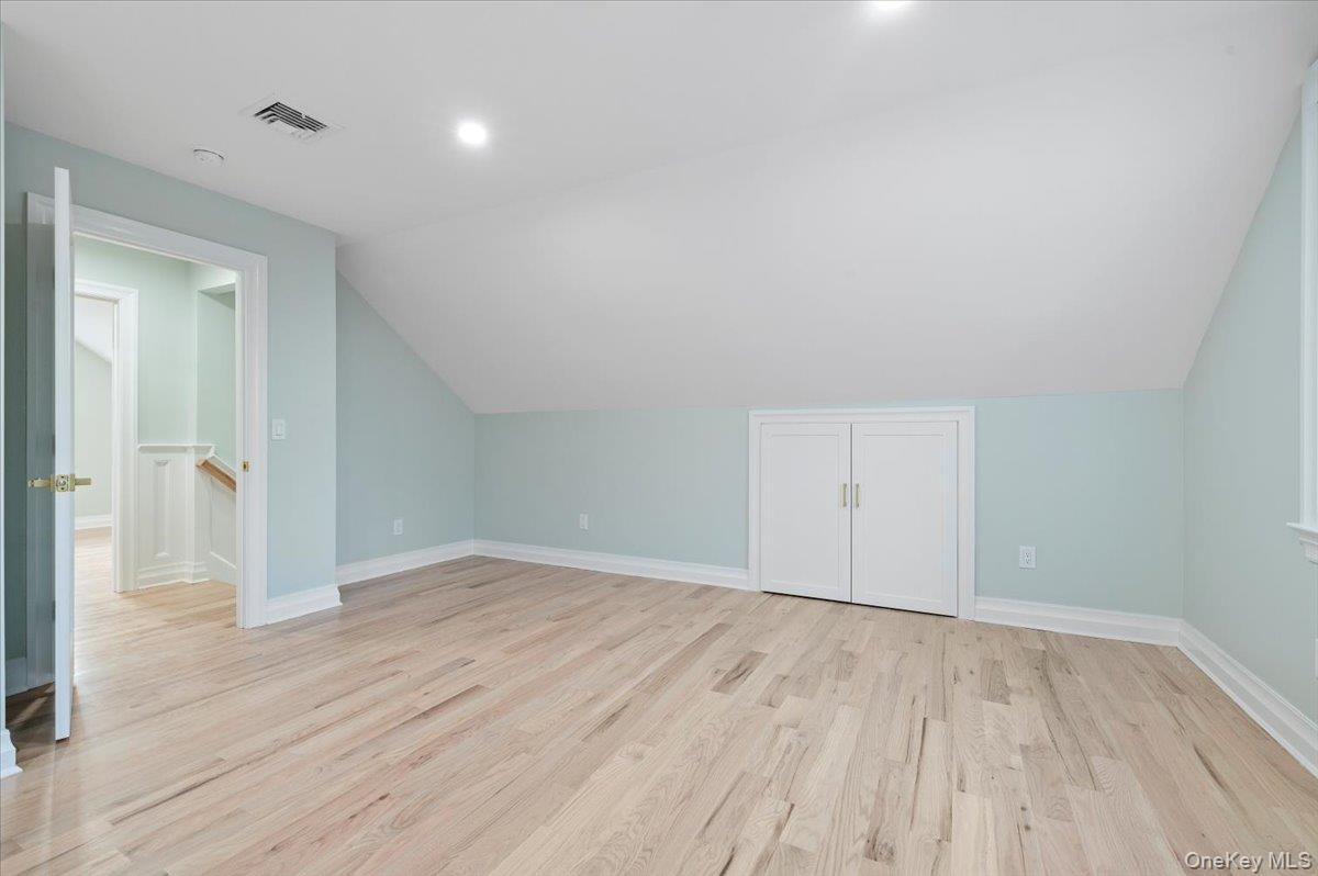 168 Martens Avenue Valley Stream, NY 11580 - Photo 18 of 26 Additional living space featuring light wood finished floors and lofted ceiling