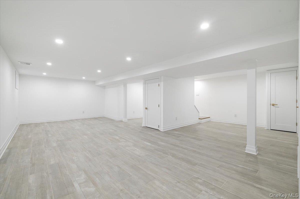 168 Martens Avenue Valley Stream, NY 11580 - Photo 19 of 26 Finished below grade area with recessed lighting and light wood-style flooring