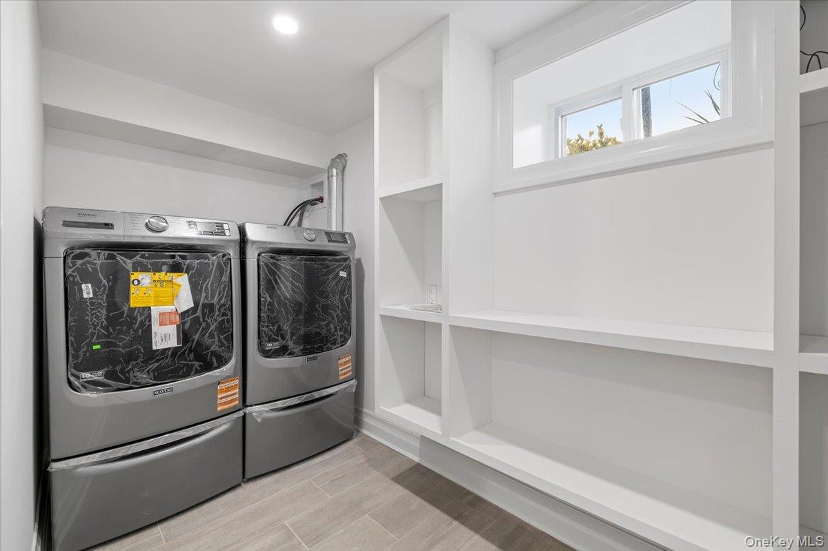 168 Martens Avenue Valley Stream, NY 11580 - Photo 22 of 26 Laundry room with washing machine and dryer and wood tiled floors