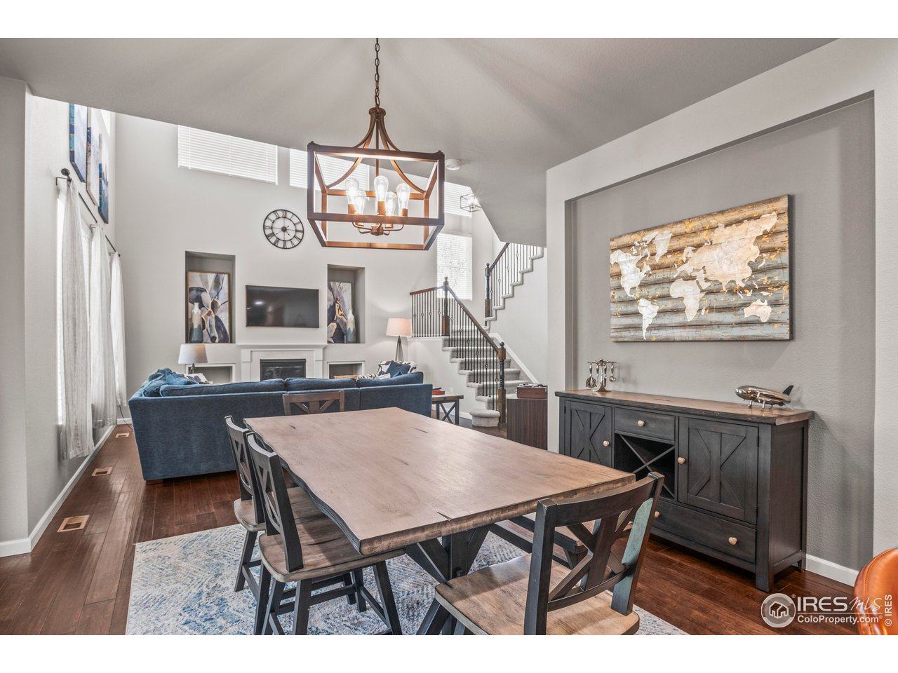 9570 Kendrick Way Arvada, CO 80007 - Photo 11 of 43 a dining room with wooden floor a chandelier a wooden table and chairs