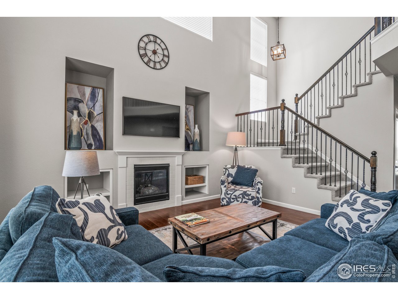 9570 Kendrick Way Arvada, CO 80007 - Photo 12 of 43 a living room with furniture a flat screen tv and a fireplace