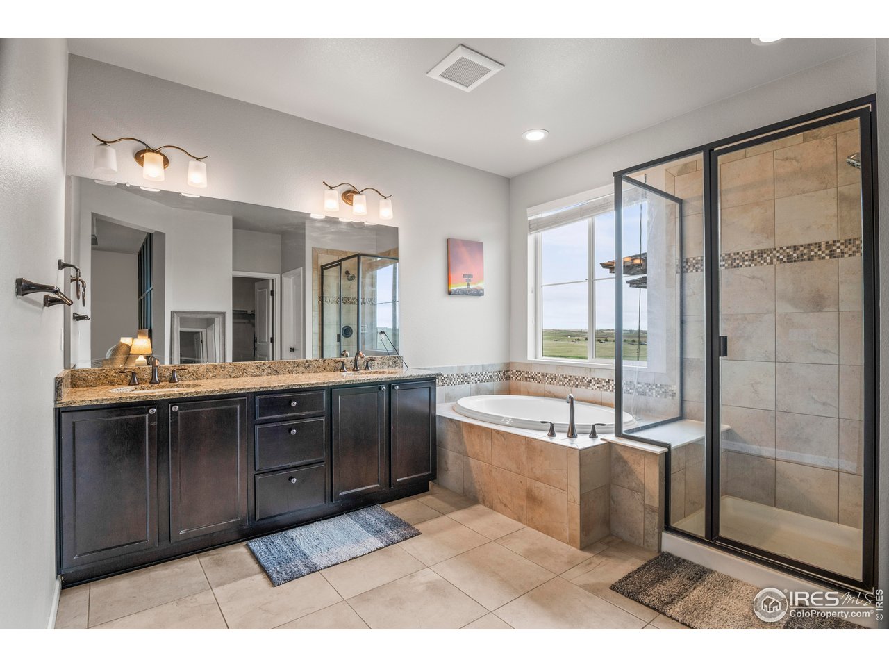 9570 Kendrick Way Arvada, CO 80007 - Photo 20 of 43 a spacious bathroom with a tub sink shower and mirror