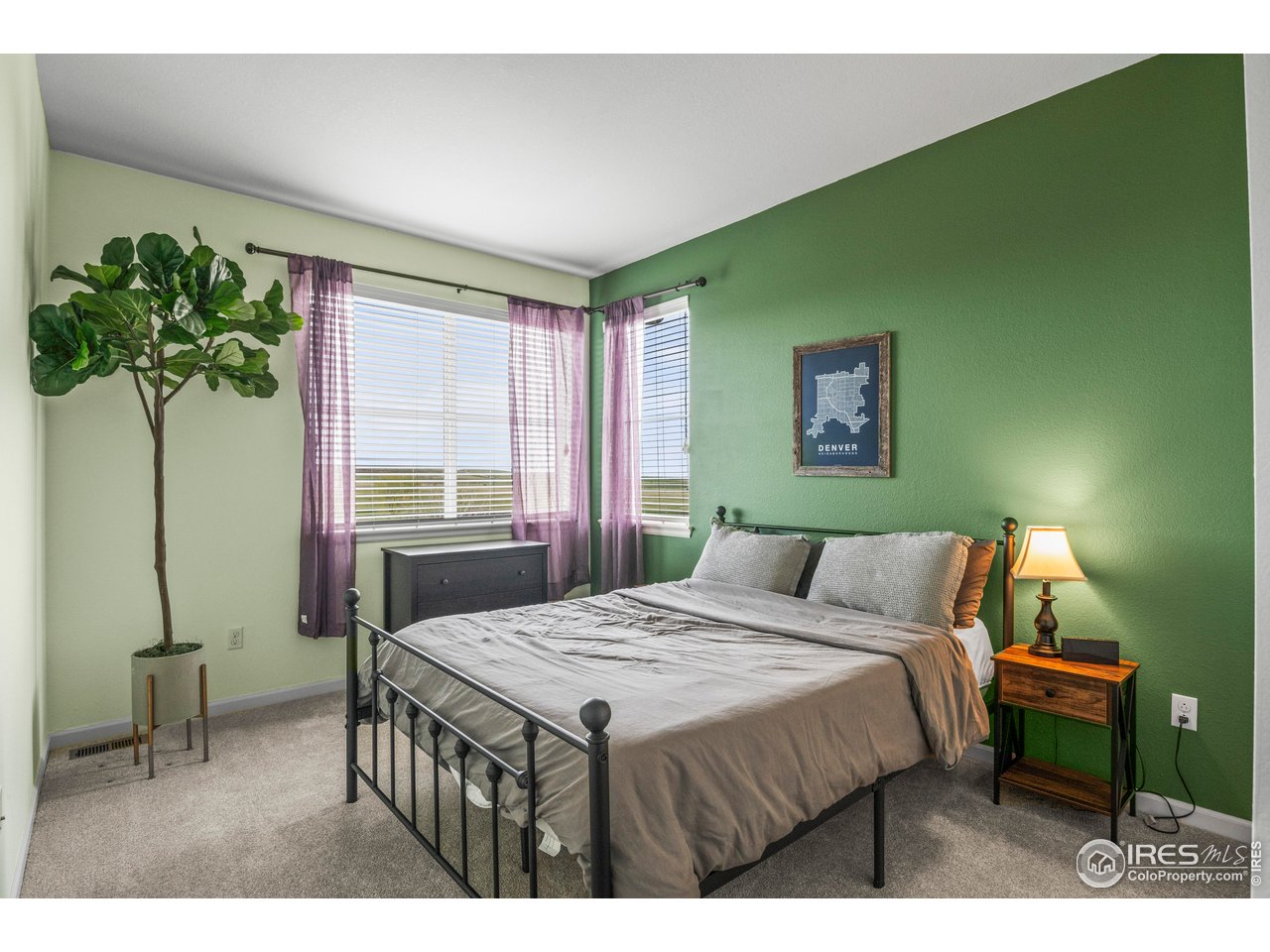 9570 Kendrick Way Arvada, CO 80007 - Photo 24 of 43 a bedroom with a bed table and a potted plant