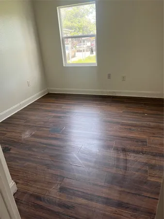 a view of a room with wooden floor and a sink