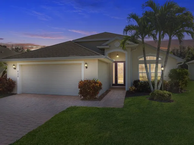 a view of a house with a yard and a garden