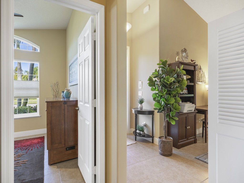 605 Monarch Way Sebastian, FL 32958 - Photo 19 of 36 a view of a hallway with wooden floor and a potted plant