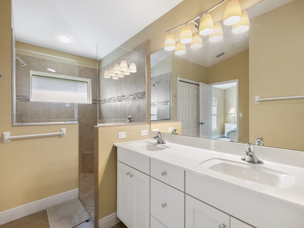 605 Monarch Way Sebastian, FL 32958 - Photo 20 of 36 a bathroom with a double vanity sink mirror and